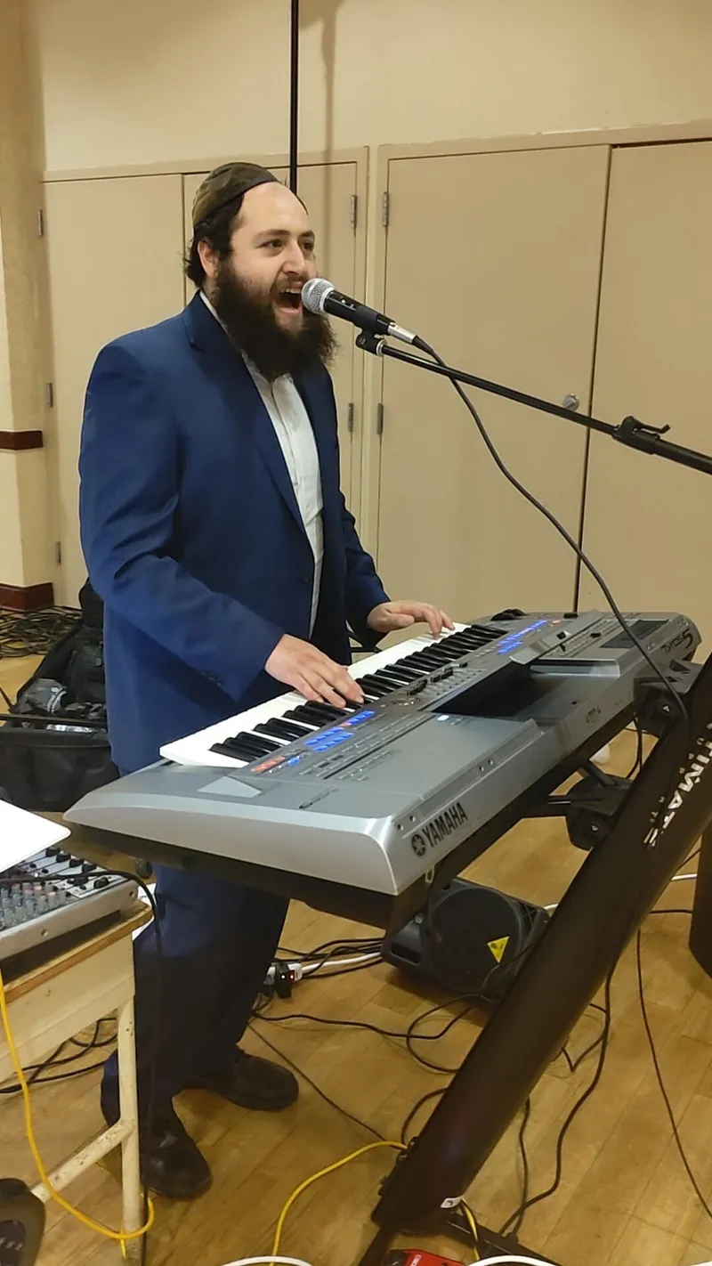 Motty playing keyboard live at a simcha